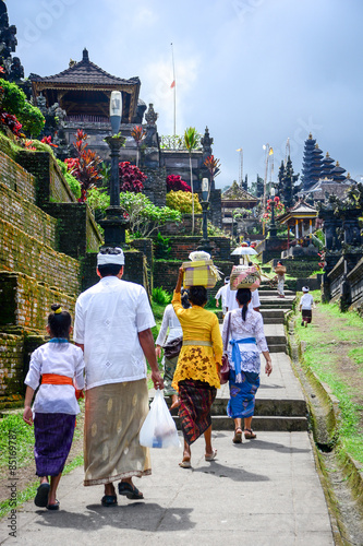 Balinese people walk in traditional dress in Pura Besakih