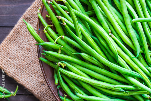 Green beans or string beans on rustic wood.