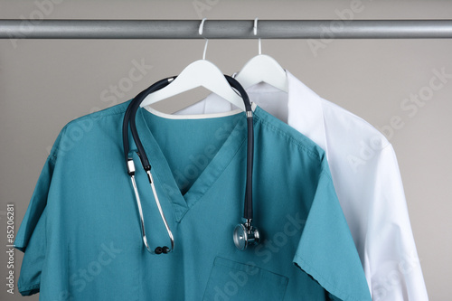 Scrubs with Stethoscope and Lab Coat on Hanger