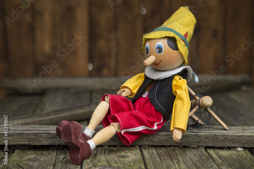Old wooden pinocchio marionette toy .