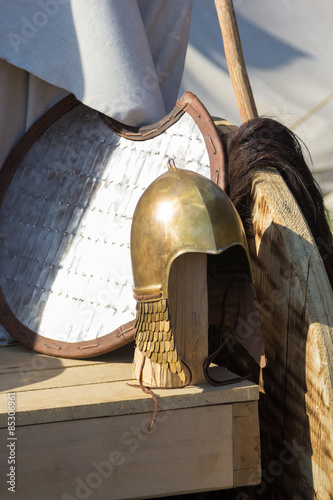 shield and helmet on wooden table