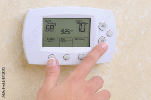 Closeup of Hand and Thermostat