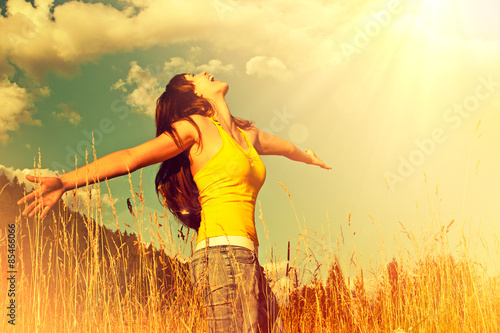 girl standing in a field with arms wide open-summerfield 01