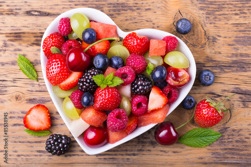 Fruit salad in heart shaped bowl - healthy eating