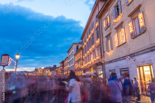 PISA, ITALY - JUNE 16, 2015: Tourists and locals in Lungarni for