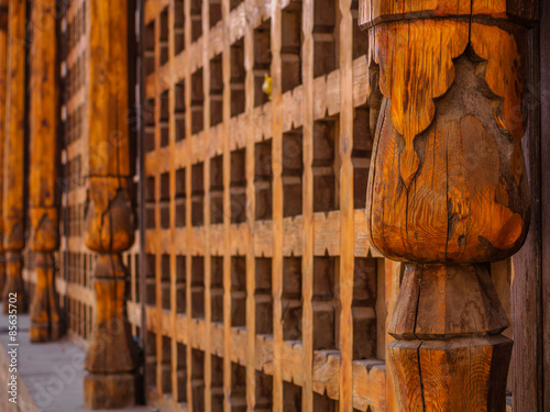 Decorative carved wooden lattice on the old window in Bukhara, Uzbekistan