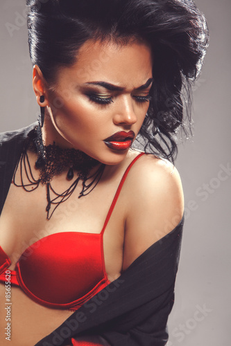 Sexy adult woman with closed eyes and make up in red bra