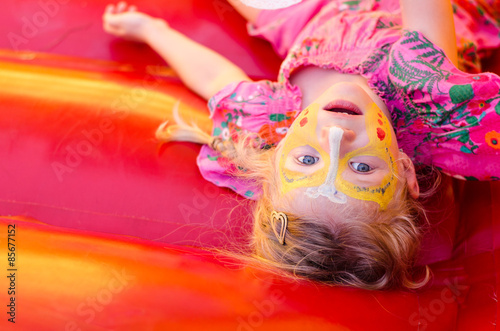 lying child with facepainting