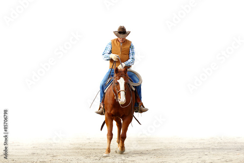 Mountain cowboy riding his horse in the dirt with a blank white background for text..