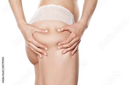 young woman checking her cellulite on her buttocks
