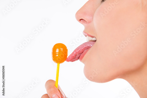 closeup photo of girl licking a lollipop