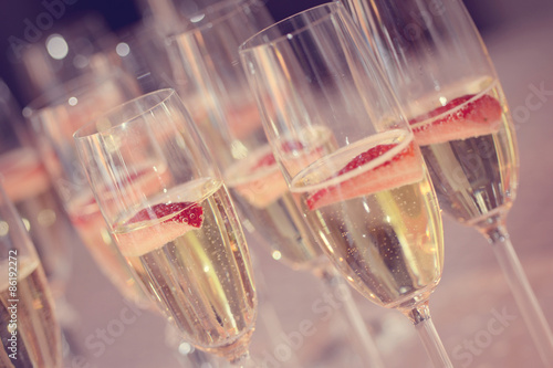 Tall glasses with sparkling wine and strawberries