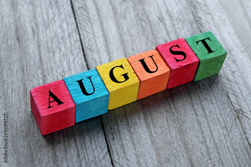 word august on colorful wooden cubes