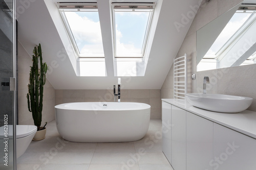 Freestanding bath in white bathroom