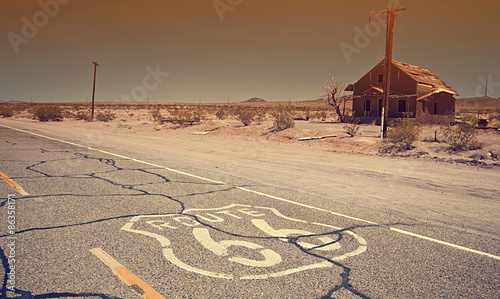 Route 66 pavement sign sunrise in California's Mojave desert.