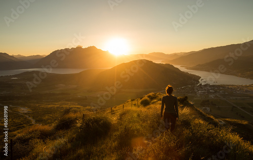 Woman silhouette at sunset on the mountain