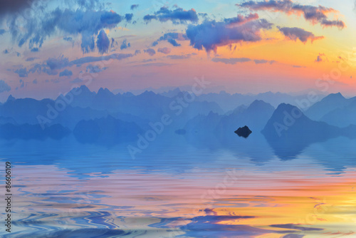 Calm water and far summer mountains in the evening