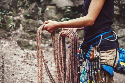 Woman holding climbing rope near the rock