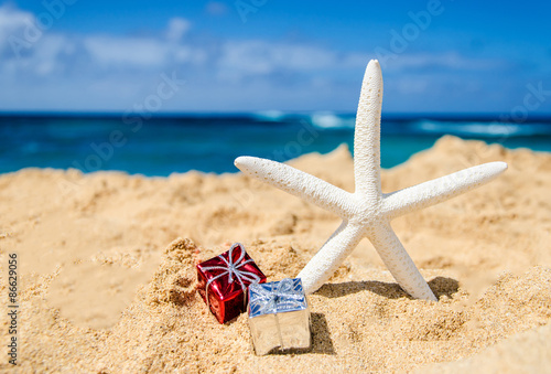Starfish with gift boxes on the sandy beach