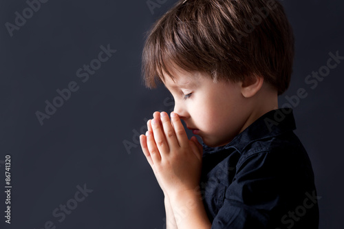 Little boy praying, child praying, isolated background