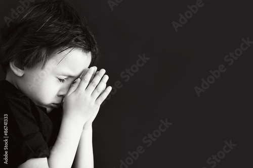 Little boy praying, child praying, isolated background