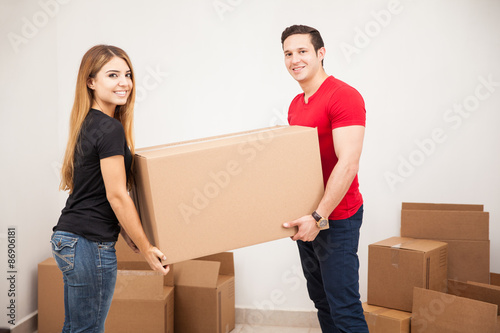 Cute couple carrying a big box