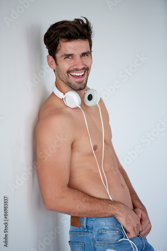 handsome young man listening music on headphones