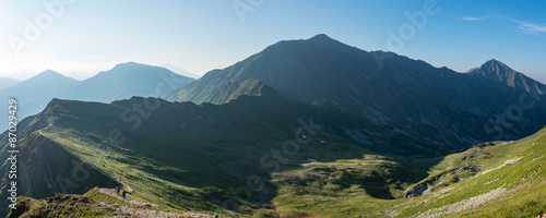 Panorama of amazing morning summer mountains with hikers