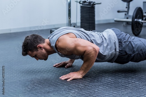 A muscular man doing a pushups 