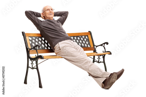 Carefree senior sitting comfortably on a bench