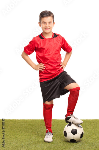 Junior soccer player stepping over a ball