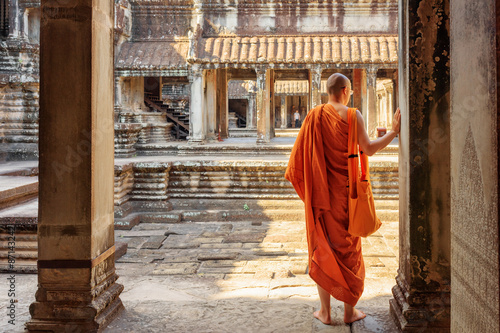 Buddhist monk exploring courtyards of Angkor Wat, Siem Reap
