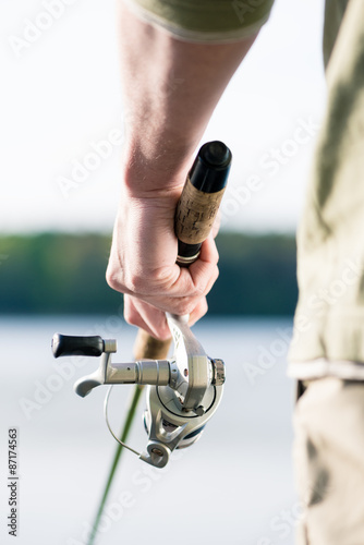 Close-up of Fisherman with fishing rod in hand