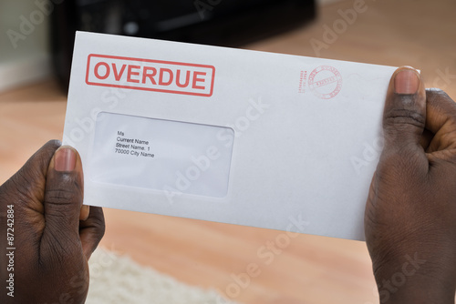 Person Holding Overdue Notice