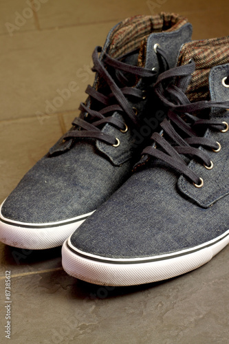 Canvas shoes. Pair of blue canvas shoes with rubber sole.