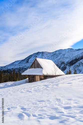 Wooden mountain hut in winter landscape of Gasienicowa valley, Tatra Mountains, Poland