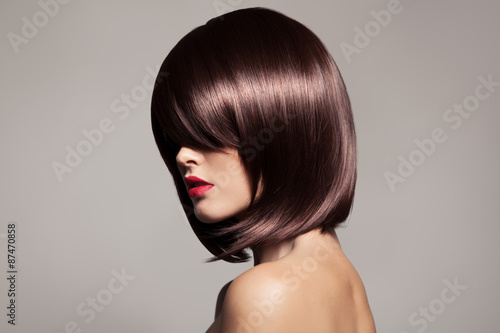 Beauty model with perfect long glossy brown hair. Close-up portr