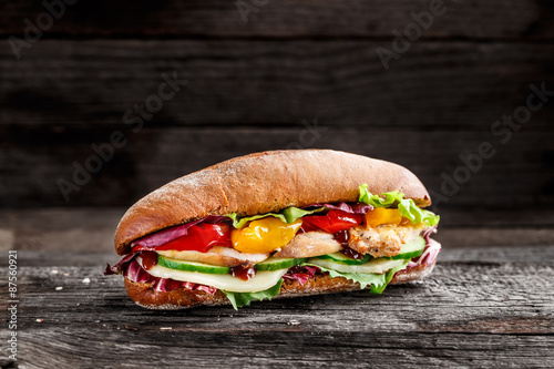 Sandwich with chicken, cheese and vegetables
