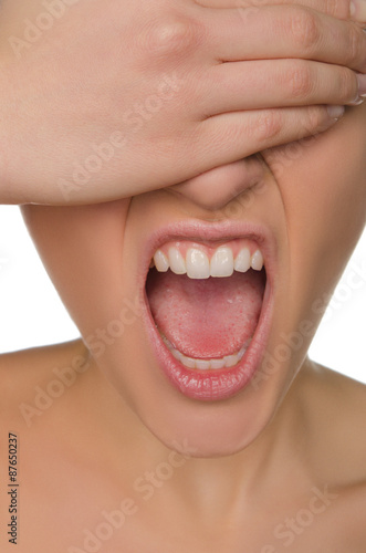 wailing woman shields her eyes from hand