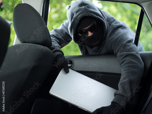 Car theft - a laptop being stolen through the window of an