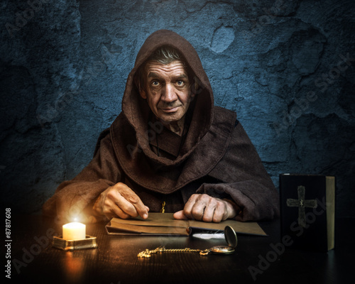 .Monk - priest.by candlelight - Bible reading