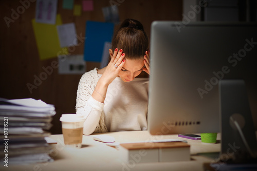 Young and beautiful businesswoman tired from work in the office