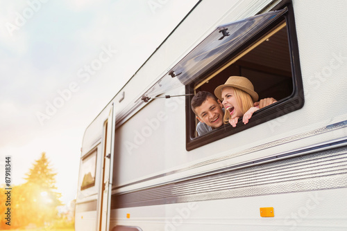 Young couple sitting in a camper van