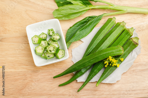 Fresh okra on wooden background