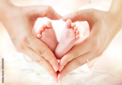 baby feet in mother hands - hearth shape 