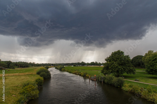 Winsen (Aller), Germany - July 29, 2015: Photograph of the river Aller and an approaching summer storm.