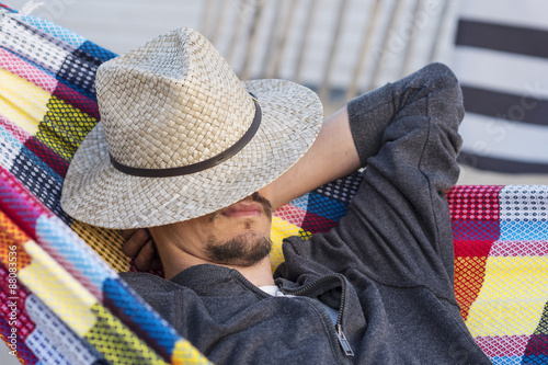 Man relaxing in a hammock at sunset