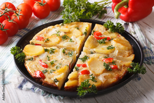 Chopped Spanish omelette with potatoes and vegetables close-up