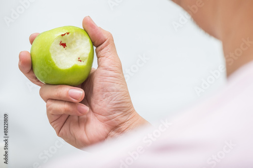 Asian man bite green apple and scurvy