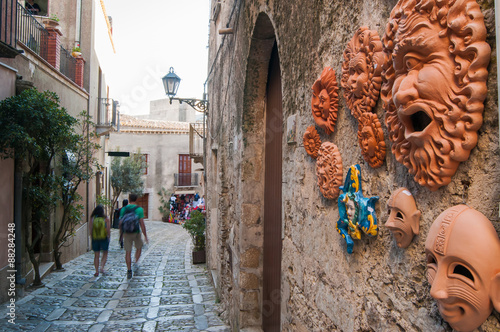 View of some ceramic souvenirs outside a tourist shop in the medieval village Erice, West Sicily, along one of its typical stone alleys